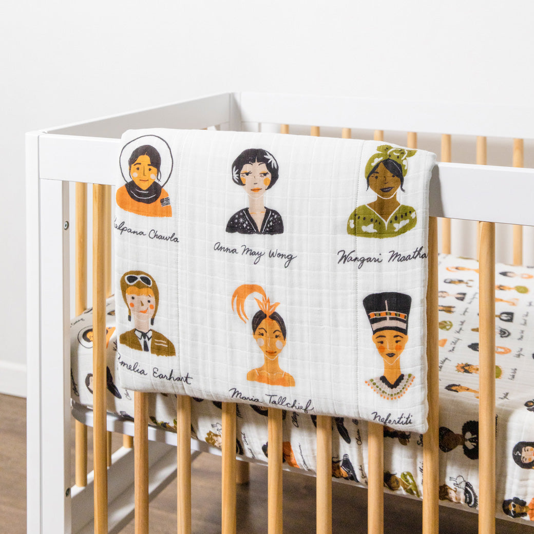 Babyletto's Quilt In 3-Layer GOTS Certified Organic Muslin Cotton on a crib rail in -- Color_Women In History
