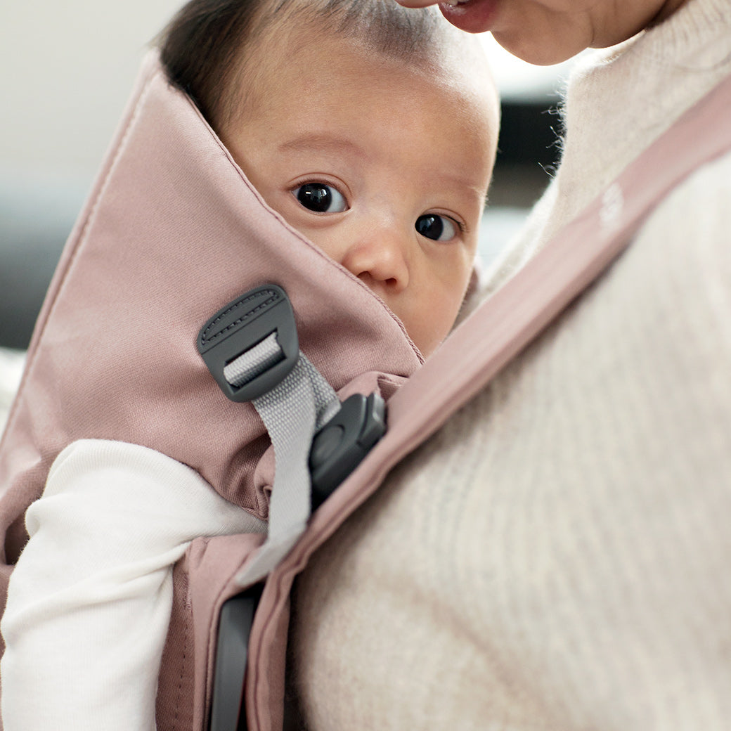 Closeup of baby in BABYBJÖRN Baby Carrier Mini in -- Color_Dusty Pink Woven