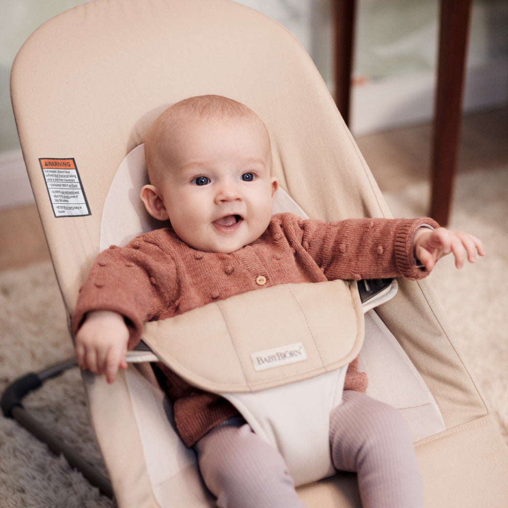Closeup of baby in BABYBJÖRN Bouncer Balance Soft in -- Color_Khaki/Beige Cotton With Light Grey Frame