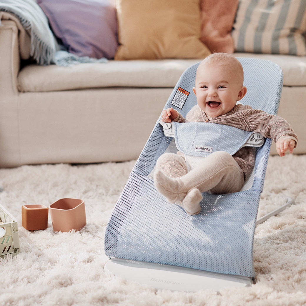 Baby laughing in the BABYBJÖRN Bouncer Balance Soft in -- Color_Sky Blue/White Mesh