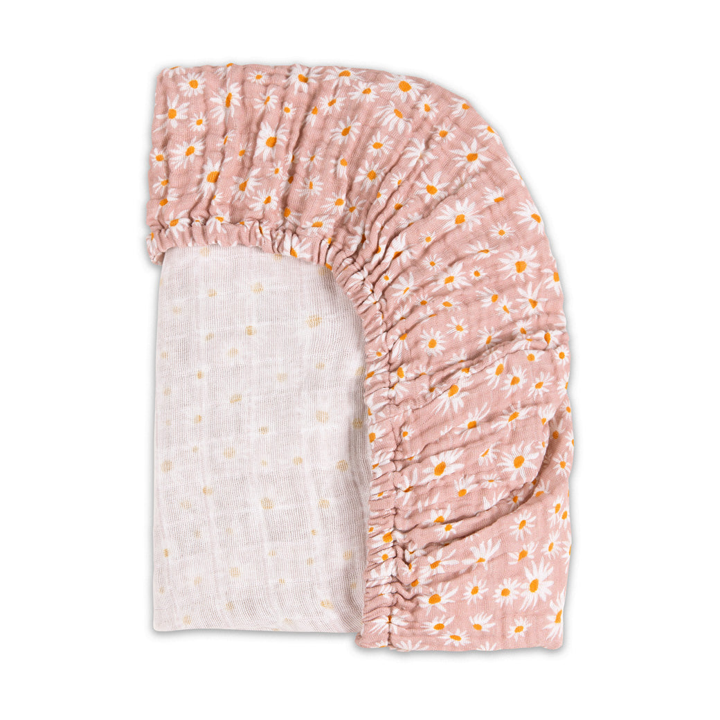 Back corner view of the Babyletto All-Stages Bassinet Sheet In GOTS Certified Organic Muslin Cotton in -- Color_Daisy