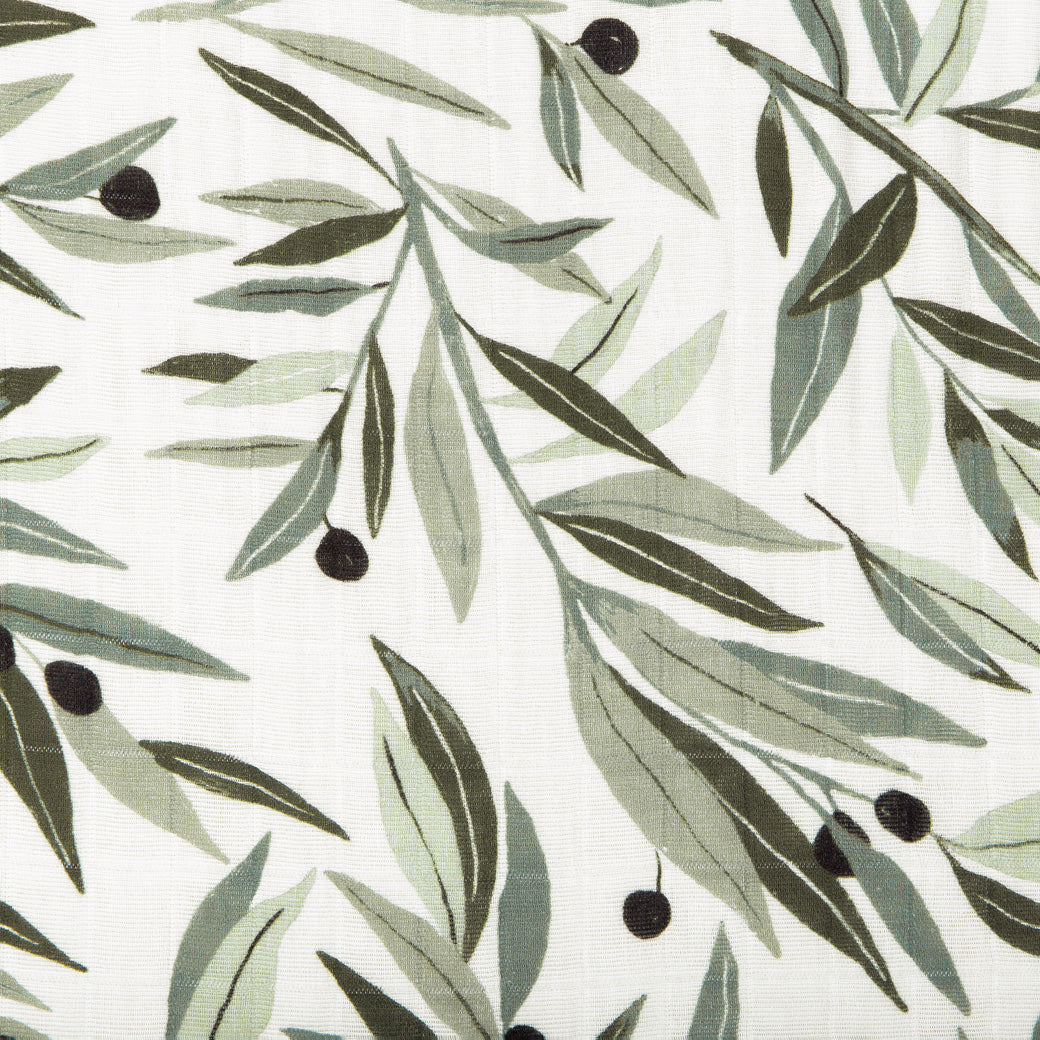 Closeup view of the Babyletto All-Stages Bassinet Sheet In GOTS Certified Organic Muslin Cotton in -- Color_Olive Branches