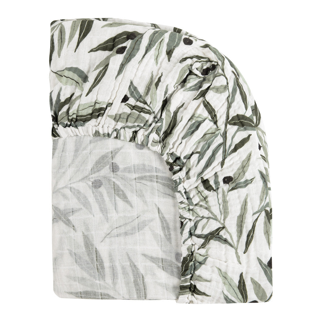 Back corner view of the Babyletto All-Stages Bassinet Sheet In GOTS Certified Organic Muslin Cotton in -- Color_Olive Branches