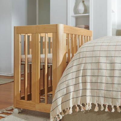Babyletto All-Stages Bassinet Sheet In GOTS Certified Organic Muslin Cotton in a crib in -- Color_Oat Stripe