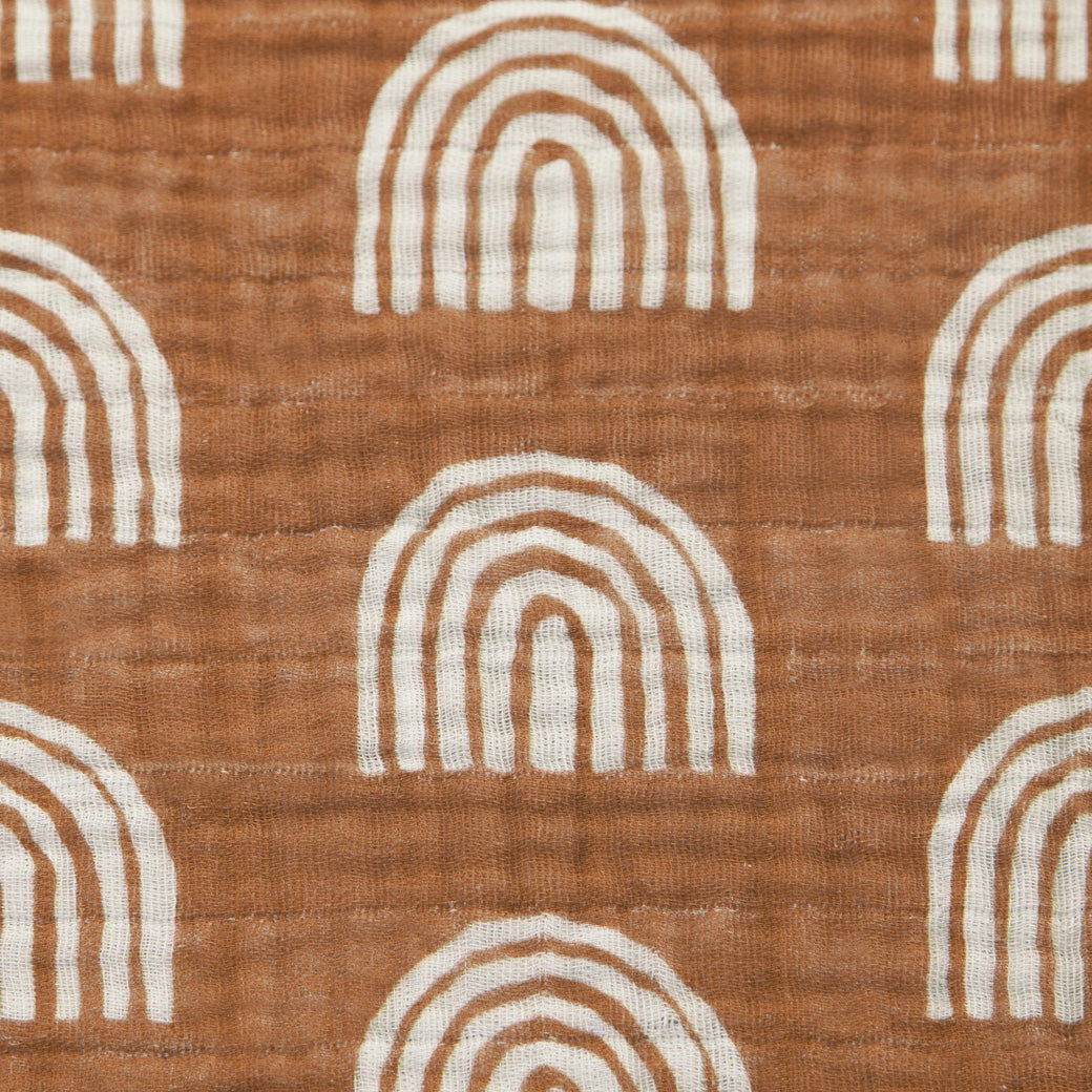 Closeup view of the Babyletto All-Stages Bassinet Sheet In GOTS Certified Organic Muslin Cotton in -- Color_Terracotta Rainbow