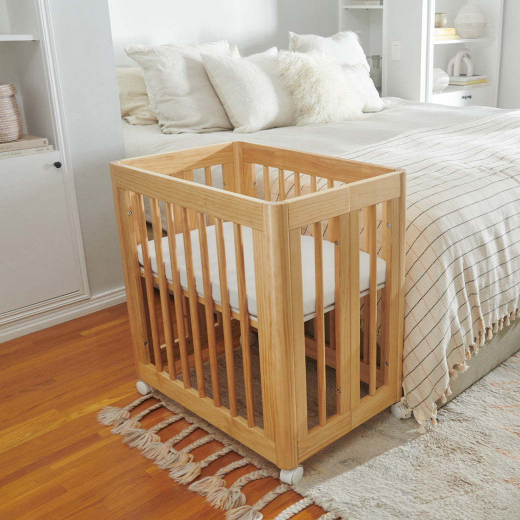 Babyletto All-Stages Bassinet Sheet In GOTS Certified Organic Muslin Cotton in a crib in the bedroom  in -- Color_White