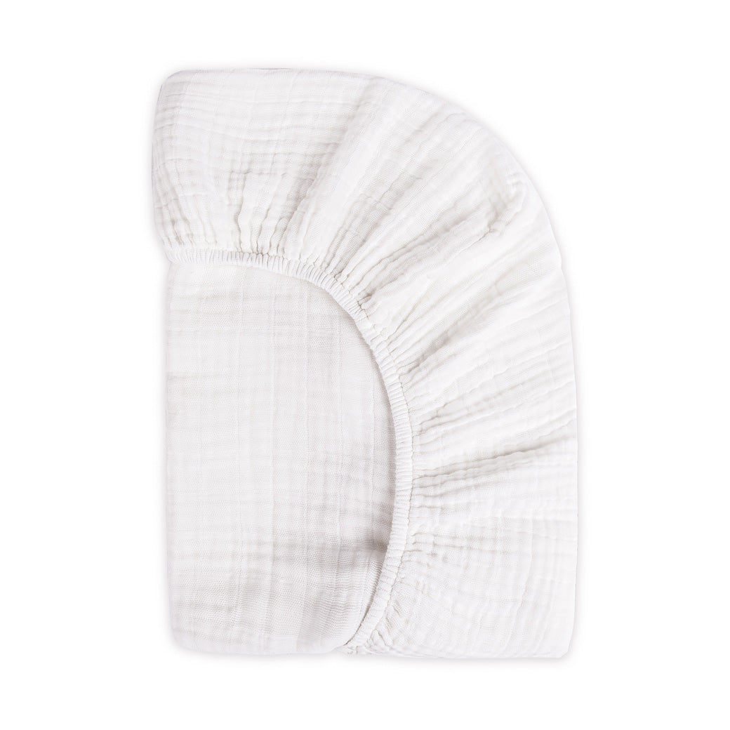 Back view of the corner of the Babyletto's Crib Sheet in GOTS Certified Organic Muslin Cotton in -- Color_White