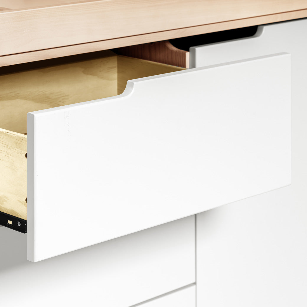 Closeup of open drawer of The Babyletto Hudson Changer Dresser in -- Color_Washed Natural/White