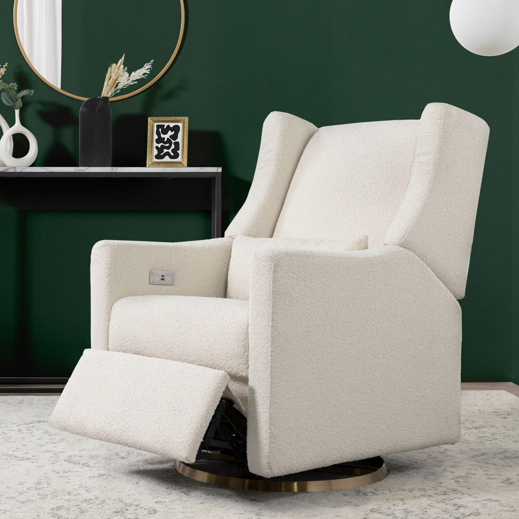 Babyletto Kiwi Glider Recliner in a dark green room with footrest up in -- Color_Ivory Boucle with Gold Base