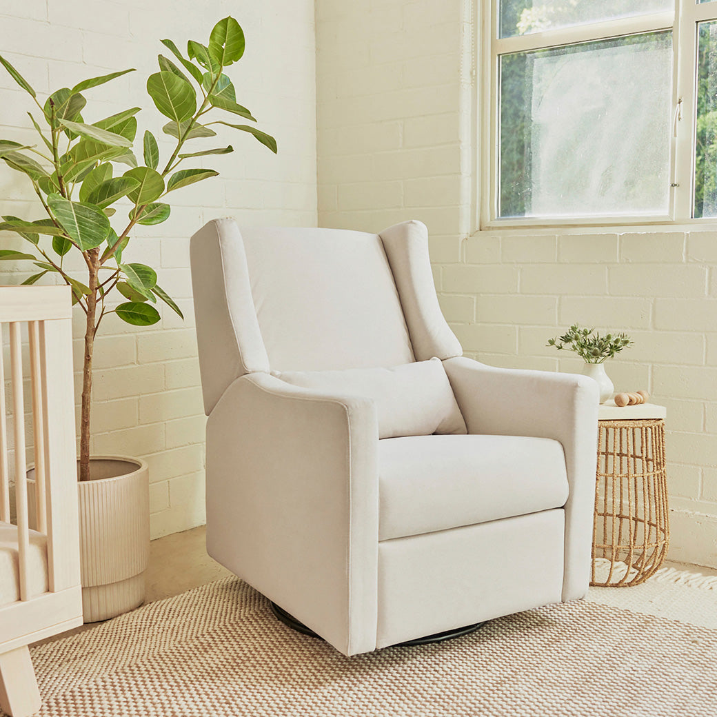 Babyletto Kiwi Glider Recliner next to a plant and window  in -- Color_Performance Cream Eco-Weave