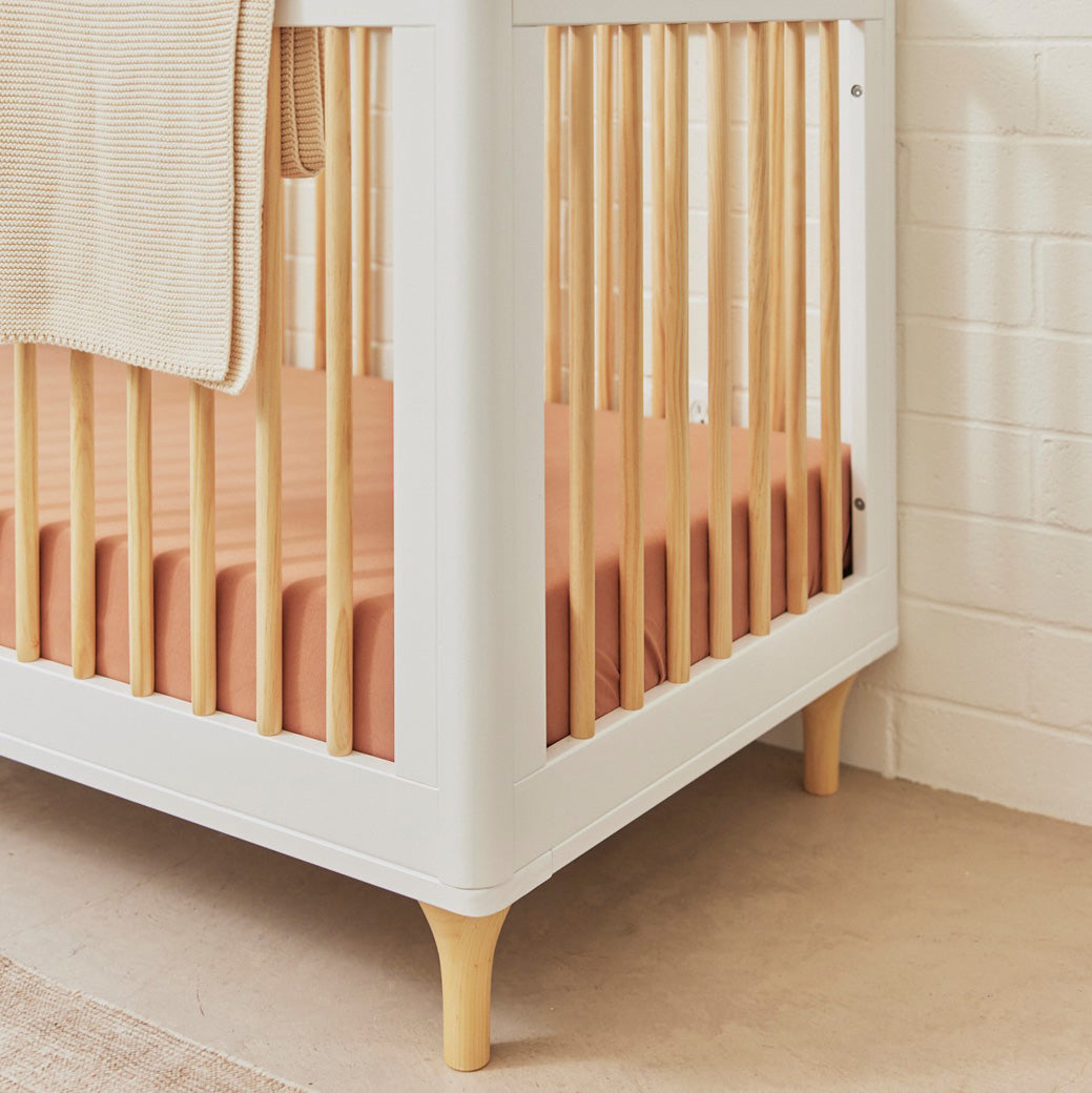 Rounded corner of The Babyletto Lolly 3-in-1 Convertible Crib in a room in -- Color_White