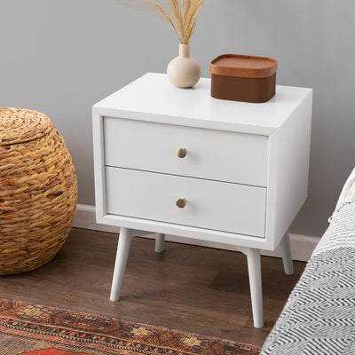 Babyletto's Palma Nightstand With USB Port next to a bed and basket  in -- Color_Warm White