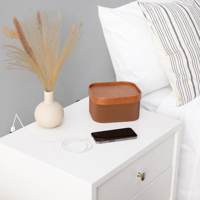 Babyletto's Palma Nightstand With USB Port with a phone charging on it  in -- Color_Warm White