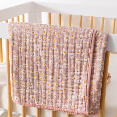 Babyletto's Quilt In 3-Layer GOTS Certified Organic Muslin Cotton over a baby crib  in -- Color_Daisy
