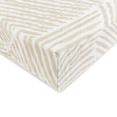 Corner of Babyletto Quilted Changing Pad Cover In GOTS Certified Organic Muslin Cotton in -- Color_Oat Stripe