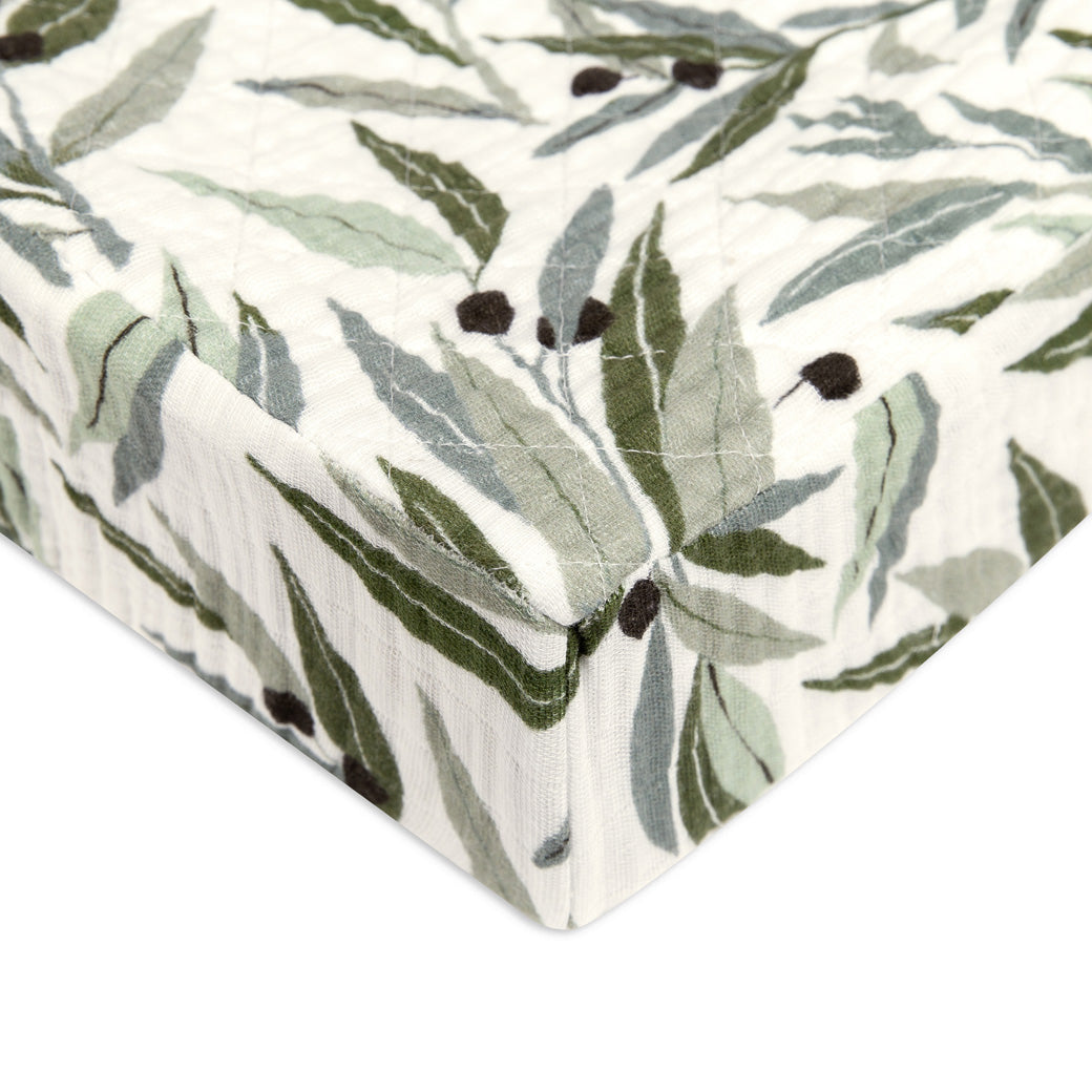 Corner of Babyletto Quilted Changing Pad Cover In GOTS Certified Organic Muslin Cotton in -- Color_Olive Branches