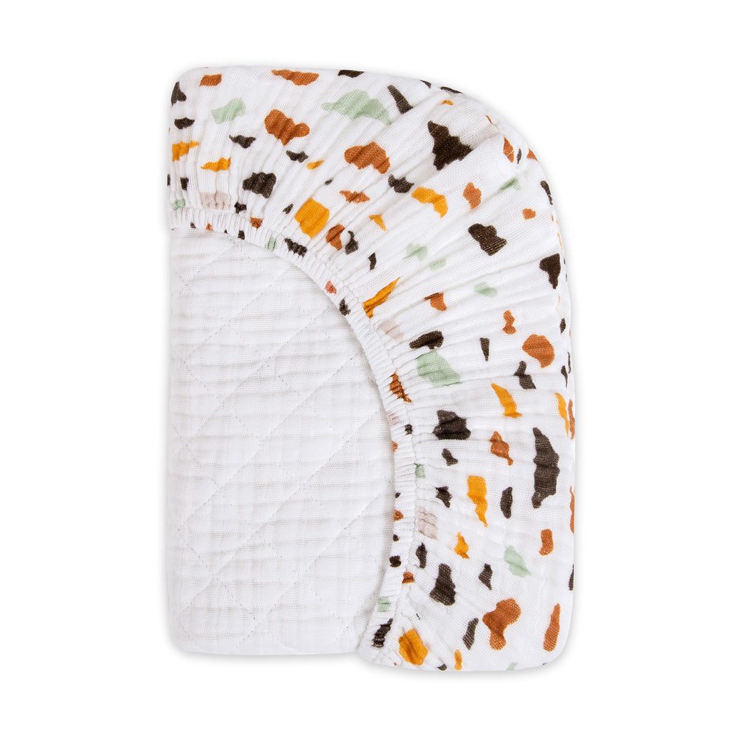 Folded corner of Babyletto Quilted Changing Pad Cover In GOTS Certified Organic Muslin Cotton in -- Color_Terrazzo
