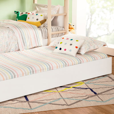 Babyletto's Universal Twin Storage Trundle Bed with colorful pillows and bedding  in -- Color_White