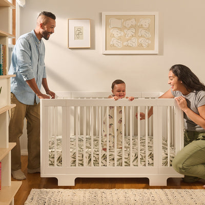 Dad and mom with a baby with the Babyletto's Yuzu 8-In-1 Convertible Crib in -- Color_White