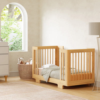 Babyletto's Yuzu 8-In-1 Convertible Crib next a basket and lamp in -- Color_Natural