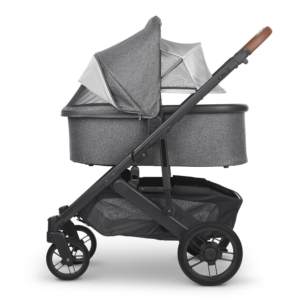 Side view of reversed bassinet with sunshade down on UPPAbaby Cruz V2 Stroller in -- Color_Gregory