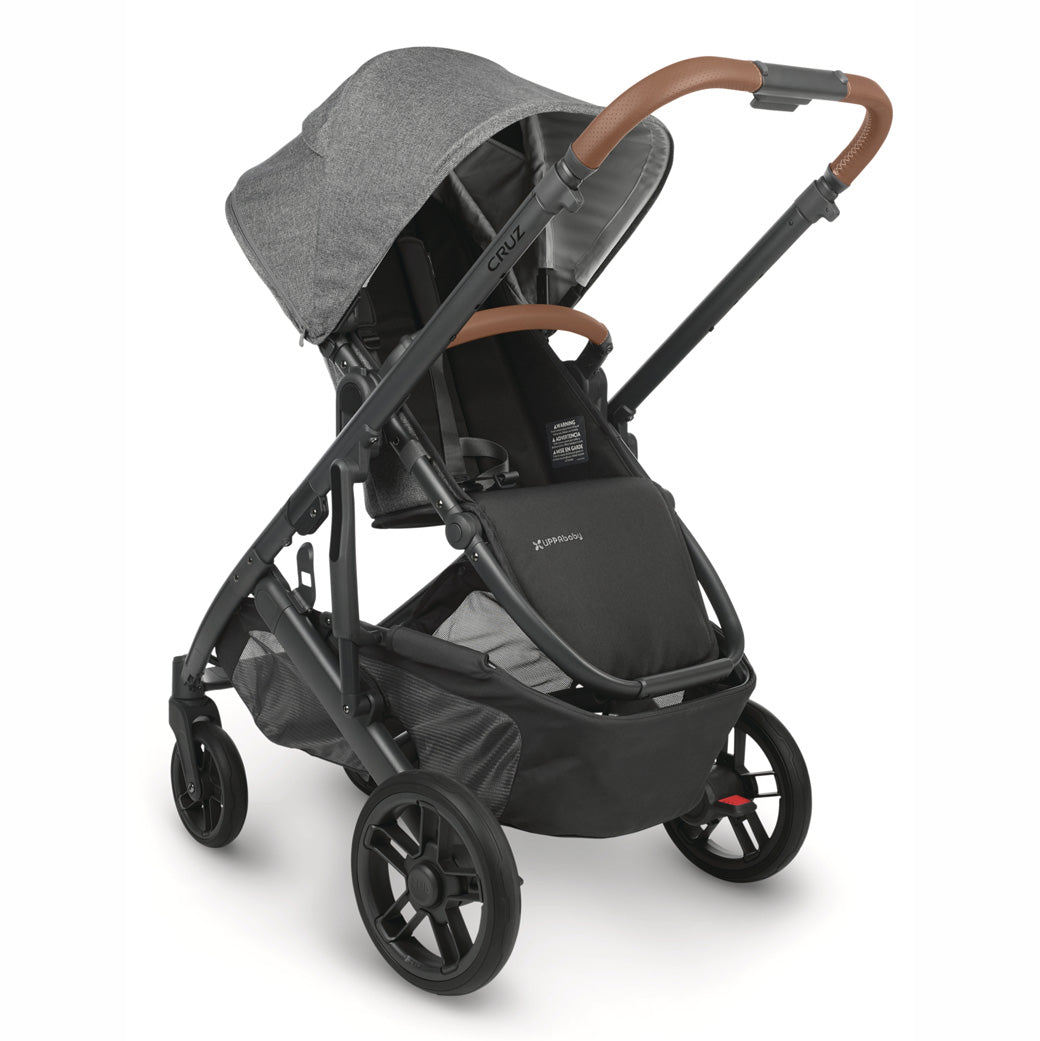View of parent-facing UPPAbaby CRUZ V2 Stroller, angled slightly to the right with black frame and heather grey fabric -- Color_Greyson