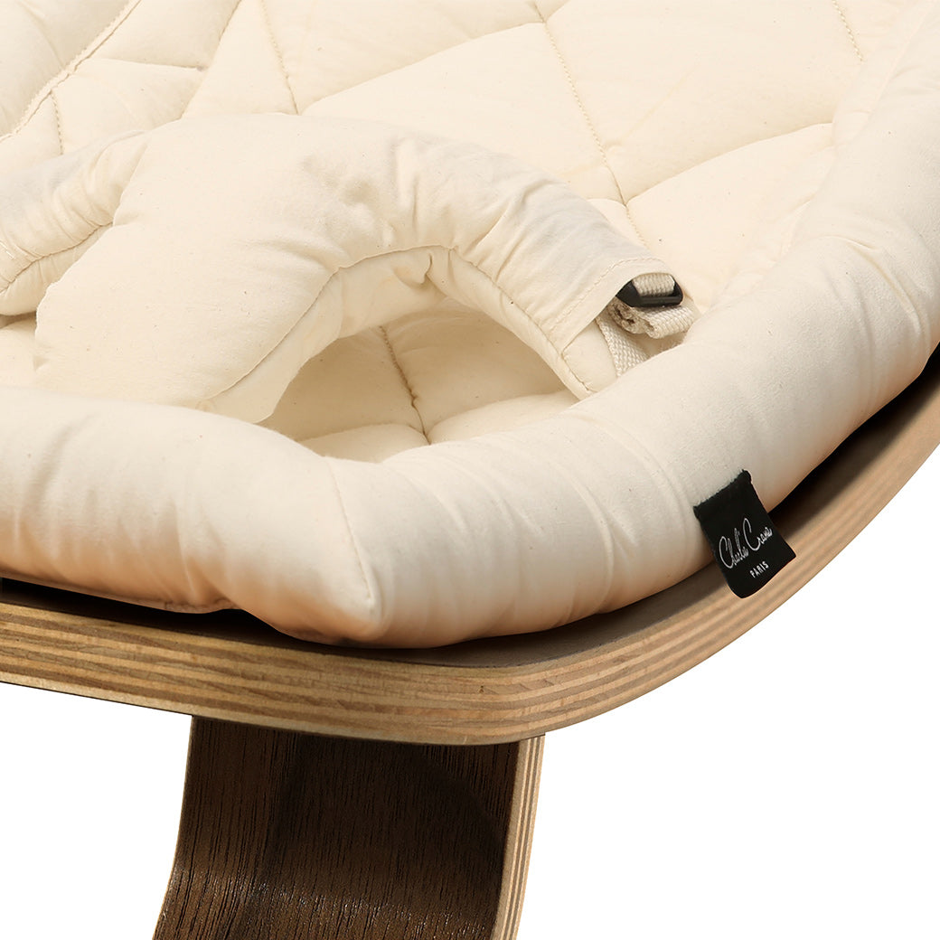 Up close picture of the front of Charlie Crane LEVO Baby Rocker in -- Color_Organic Milk _ Walnut
