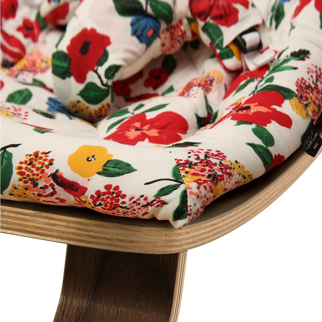 Up close of the front edge on the Charlie Crane LEVO Baby Rocker in -- Color_Lucas Du Tertre Hibiscus _ Walnut