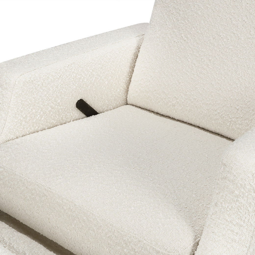 Closeup view of seat of Namesake's Crewe Recliner & Swivel Glider in -- Color_Ivory Boucle With Light Wood Base
