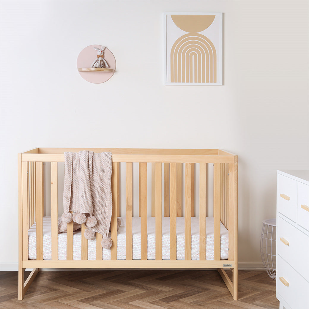 Dadada Austin 3-in-1 Crib with a blanket over the rail  in -- Color_Natural