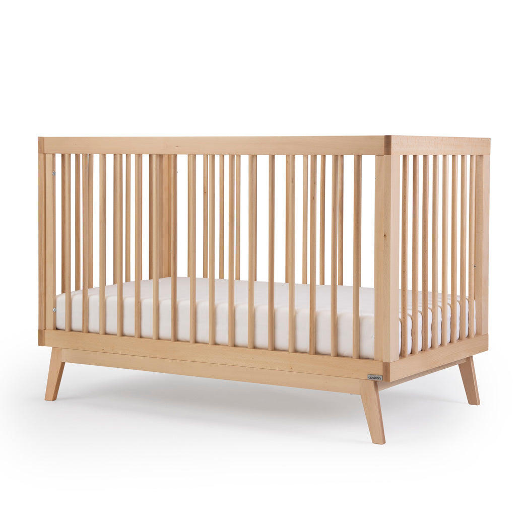 Angled view of the dadada Soho 3-in-1 Crib in -- Color_Natural