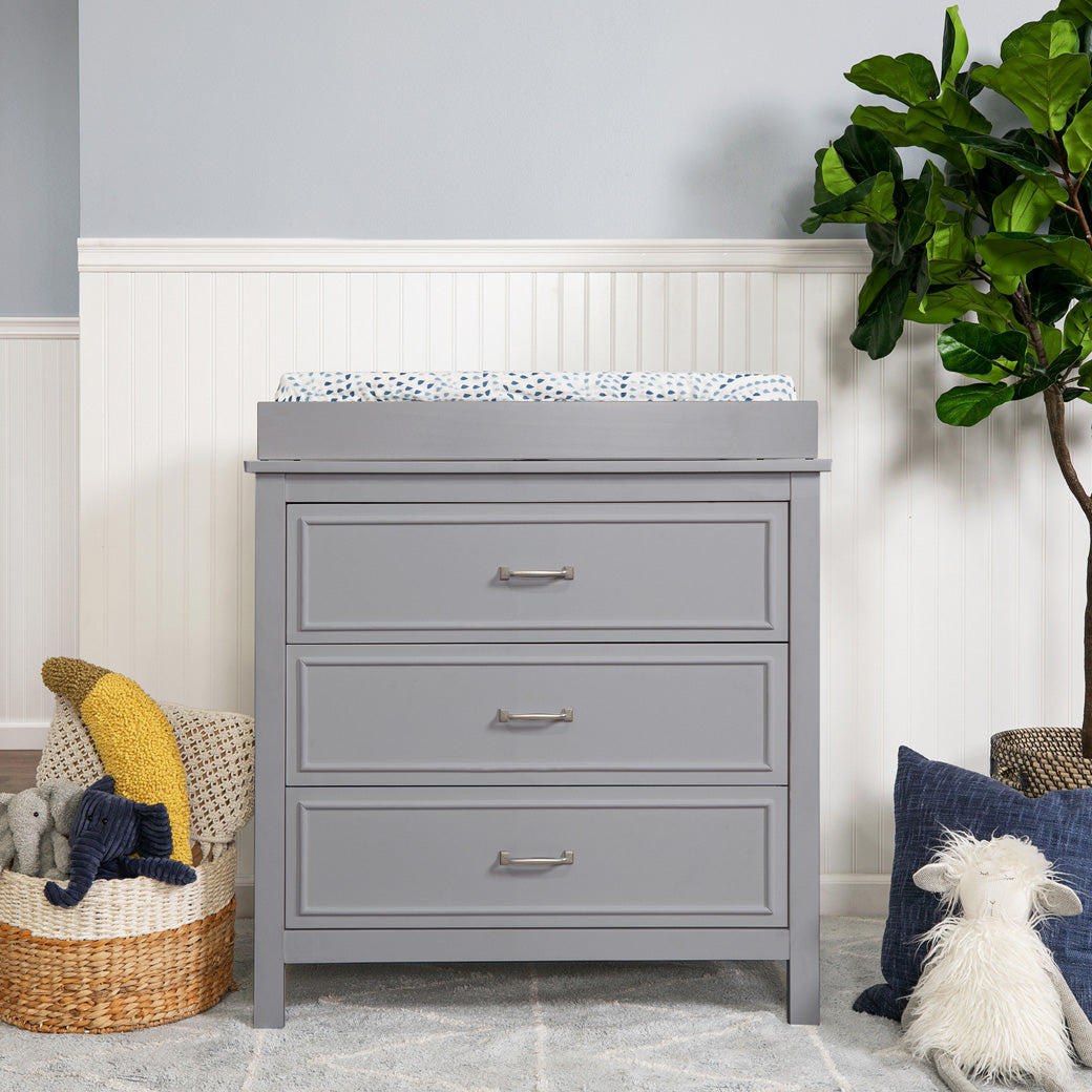 Front view lifestyle photo of The DaVinci Charlie 3-Drawer Dresser with changing tray in -- Color_Grey