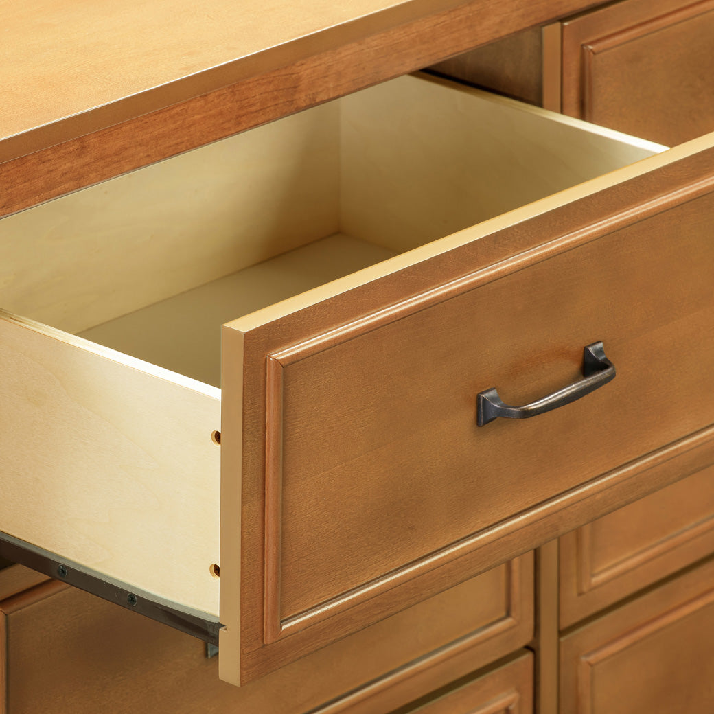 Closeup of open drawer of The DaVinci Charlie 6-Drawer Dresser in -- Color_Chestnut