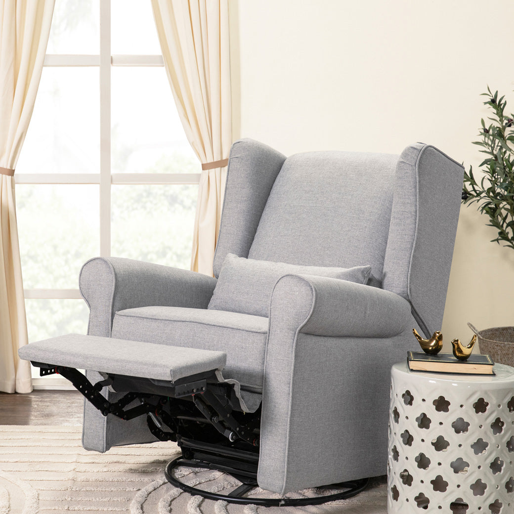 DaVinci Hayden Recliner & Swivel Glider with reclined footrest next to a window in -- Color_Misty Grey