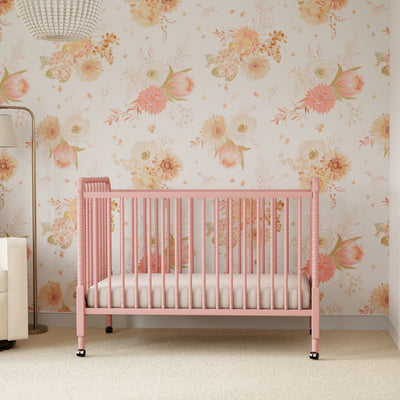 Lifestyle front view of the DaVinci’s Jenny Lind Crib in a floral room in -- Color_Blush Pink