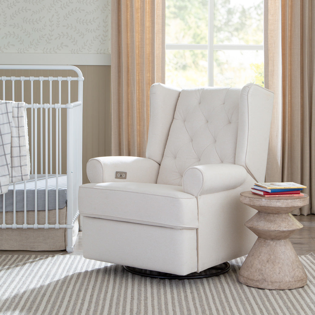 Namesake's Harbour Power Recliner next to a crib  in -- Color_Performance Cream Eco-Weave