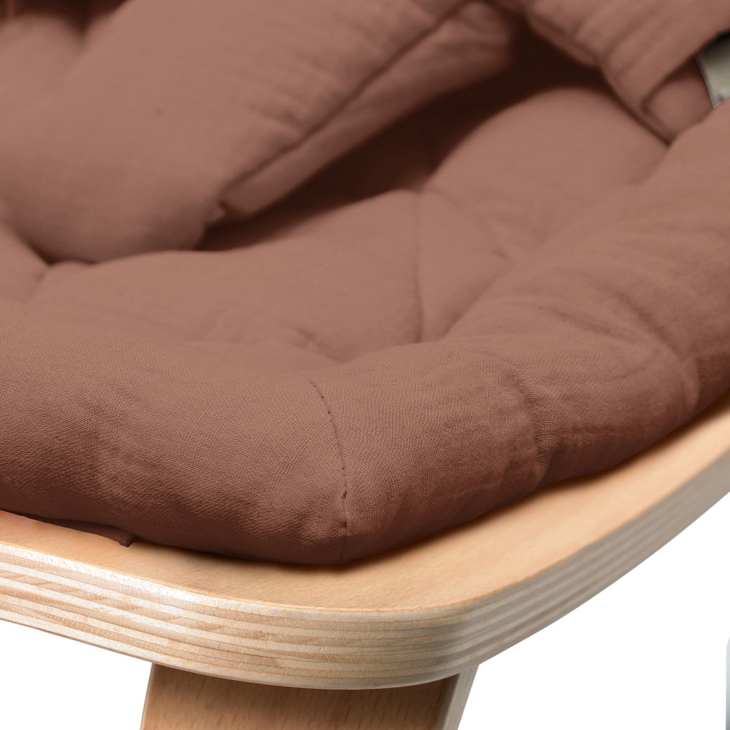 Up close of the front edge of the Charlie Crane LEVO Baby Rocker in -- Color_Bois de Rose _ Beech
