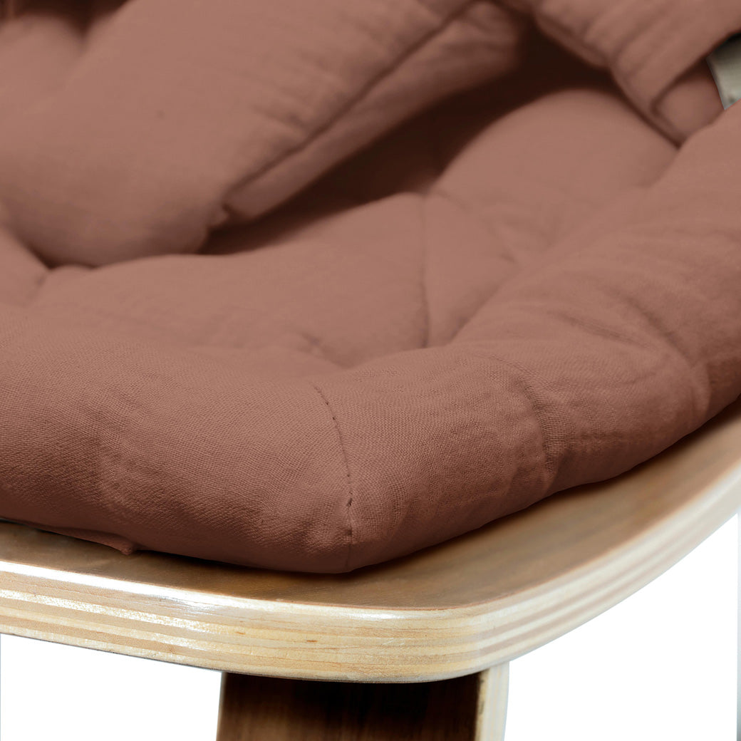 Up close of the front edge on the Charlie Crane LEVO Baby Rocker in -- Color_Bois de Rose _ Walnut