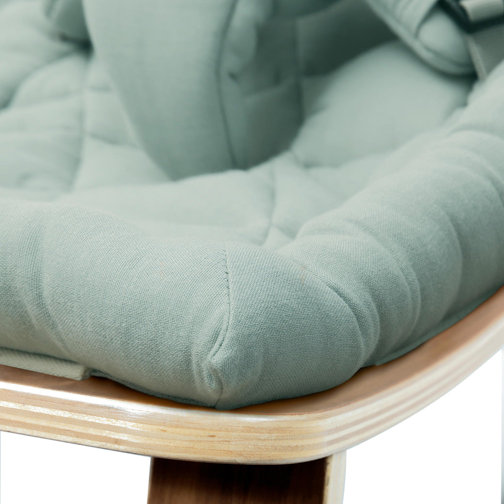 Up close of the front edge of the Charlie Crane LEVO Baby Rocker in -- Color_Farrow _ Walnut