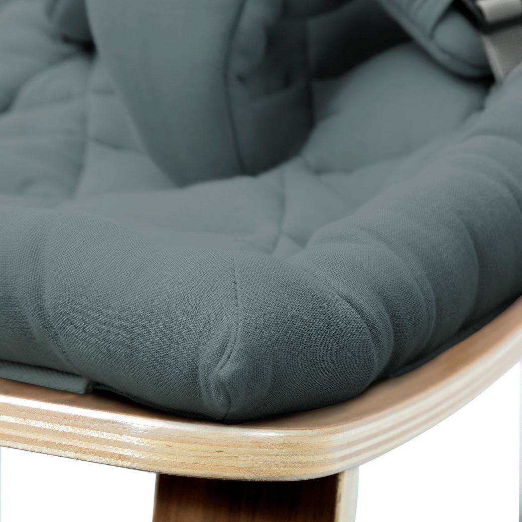 Up close of the front edge of the Charlie Crane LEVO Baby Rocker in -- Color_Orage _ Walnut