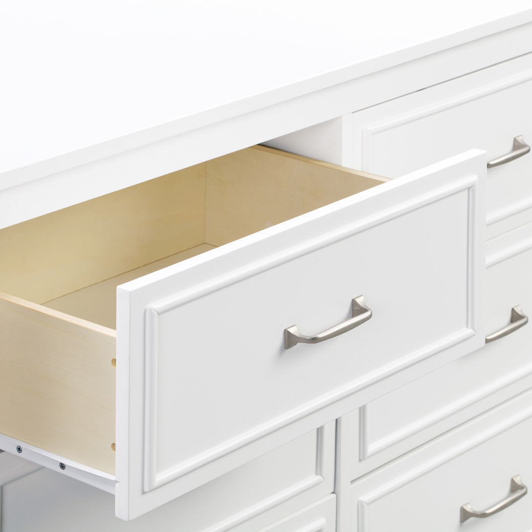 Closeup of open drawer of The DaVinci Charlie 6-Drawer Dresser in -- Color_White
