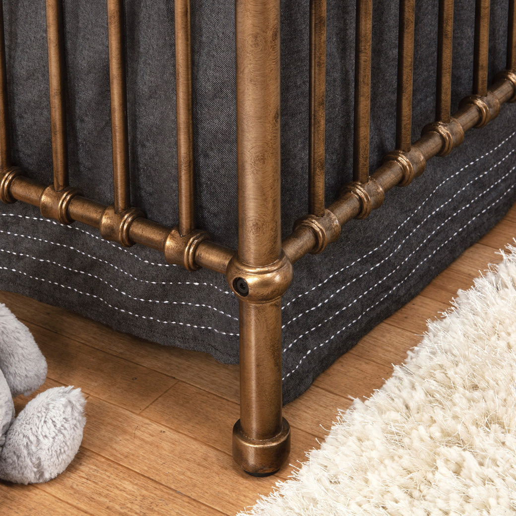 Closeup of leg of Namesake's Winston 4 in 1 Convertible Crib in -- Color_Vintage Gold