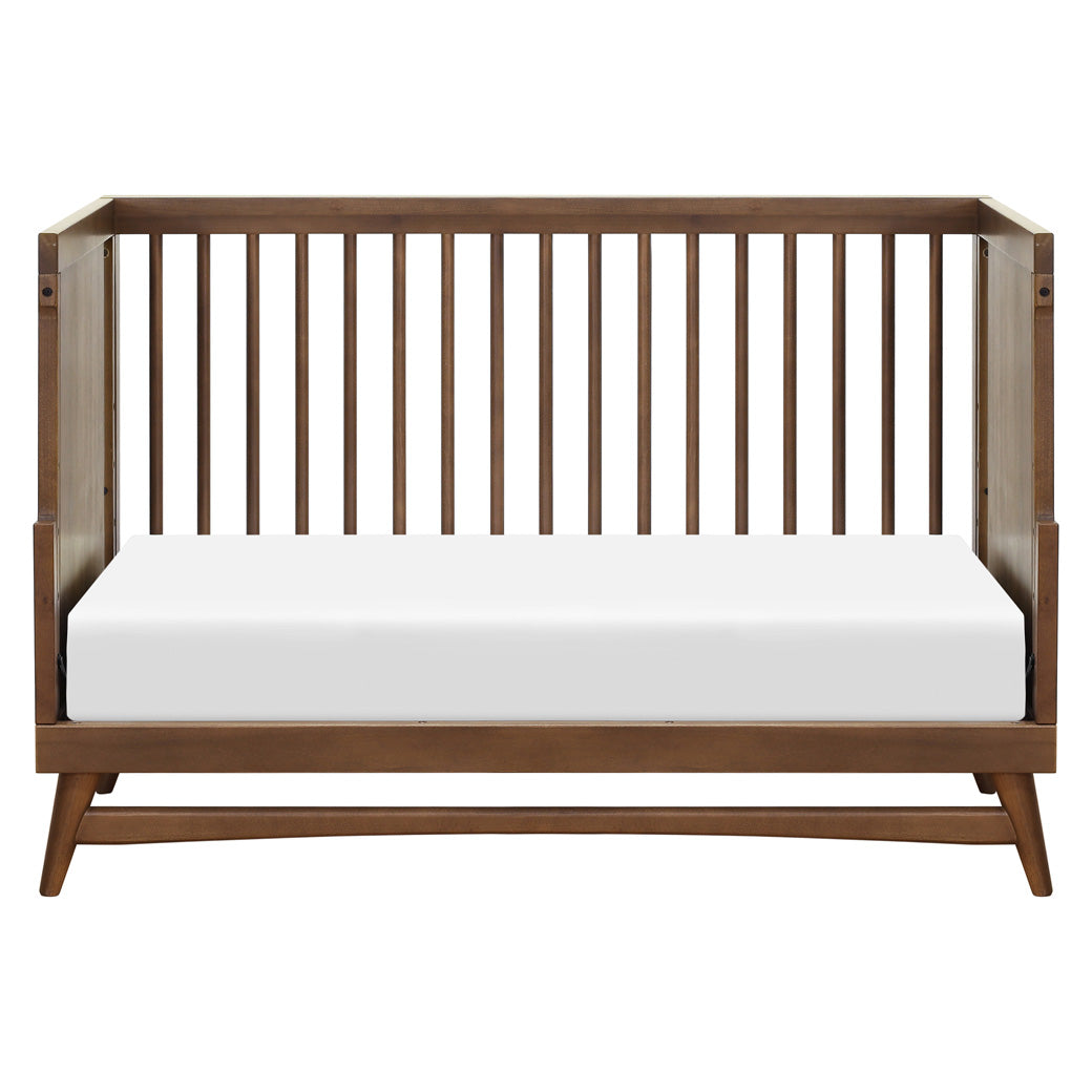 Front view of Babyletto's Peggy 3-in-1 Convertible Crib as daybed in -- Color_Natural Walnut