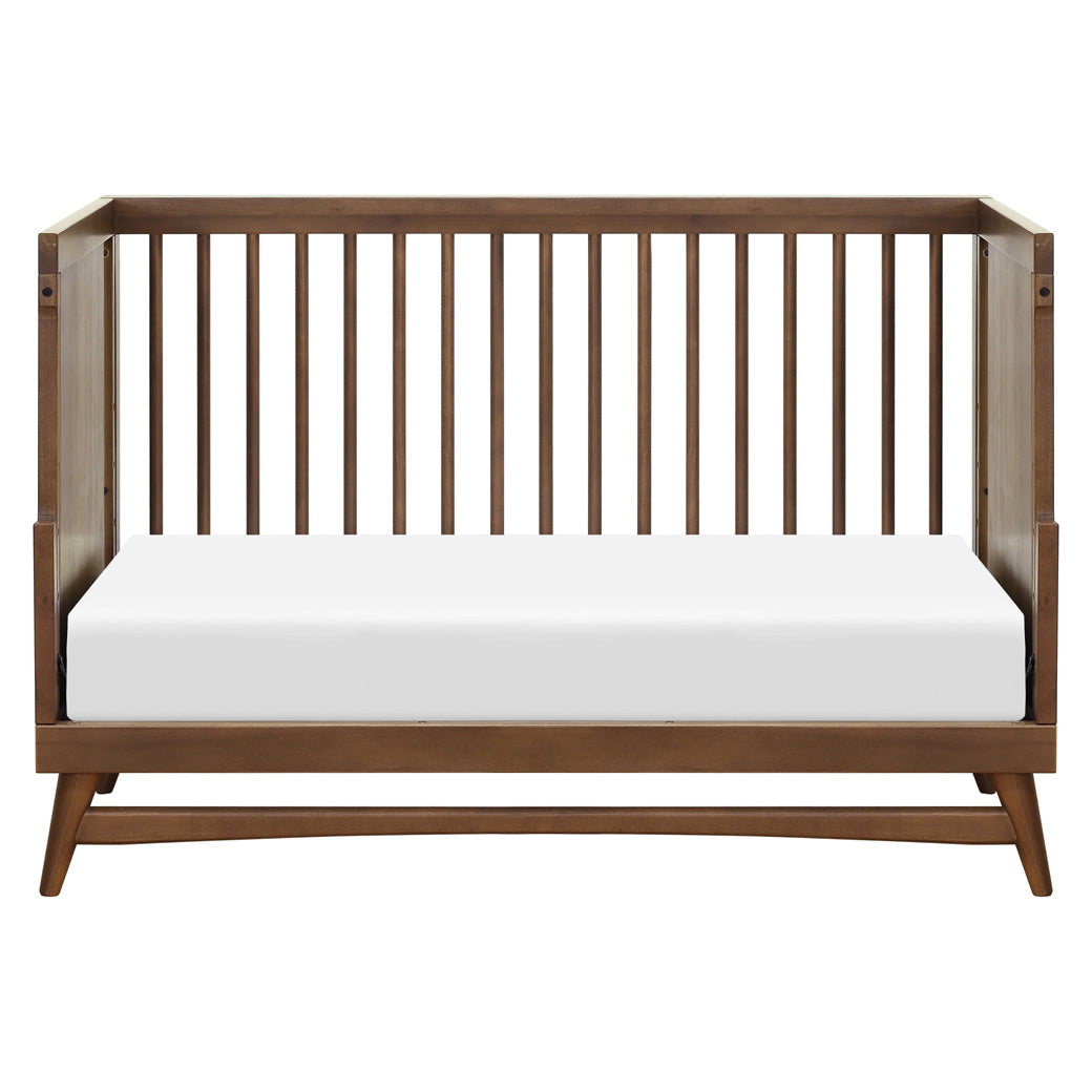 Front view of Babyletto's Peggy 3-in-1 Convertible Crib as daybed in -- Color_Natural Walnut
