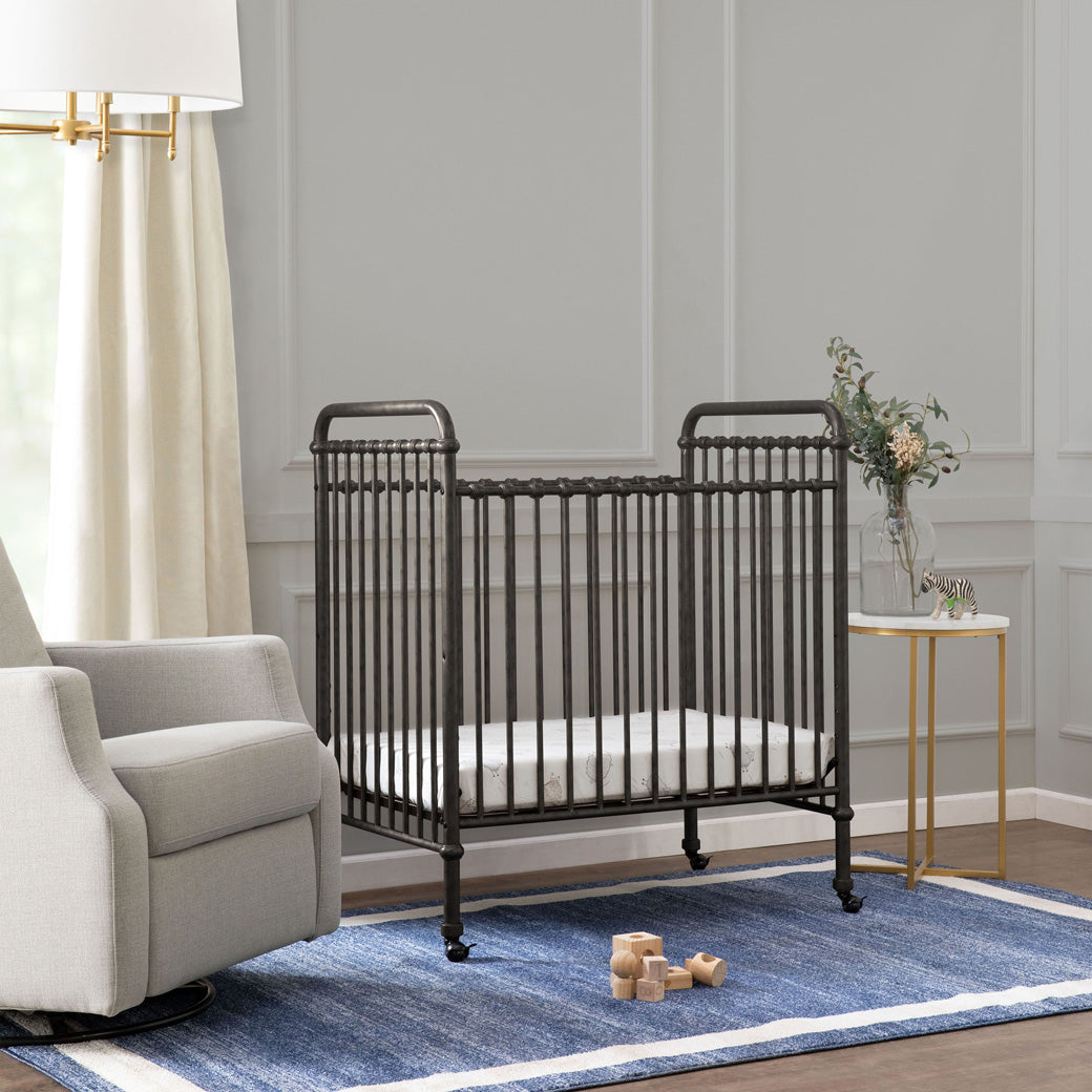 Namesake`s Abigail 3-in-1 Convertible Mini Crib next to a glider in -- Color_Vintage Iron