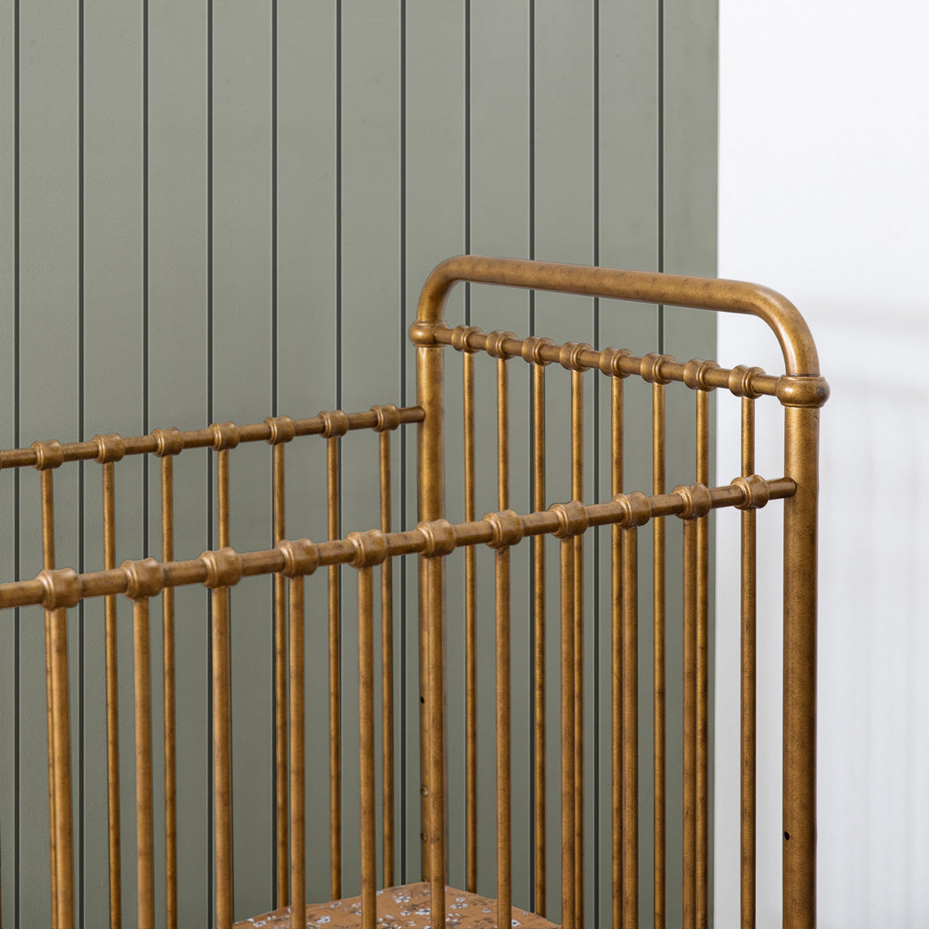 Closeup of rails of the Namesake`s Abigail 3-in-1 Convertible Mini Crib in -- Color_Vintage Gold