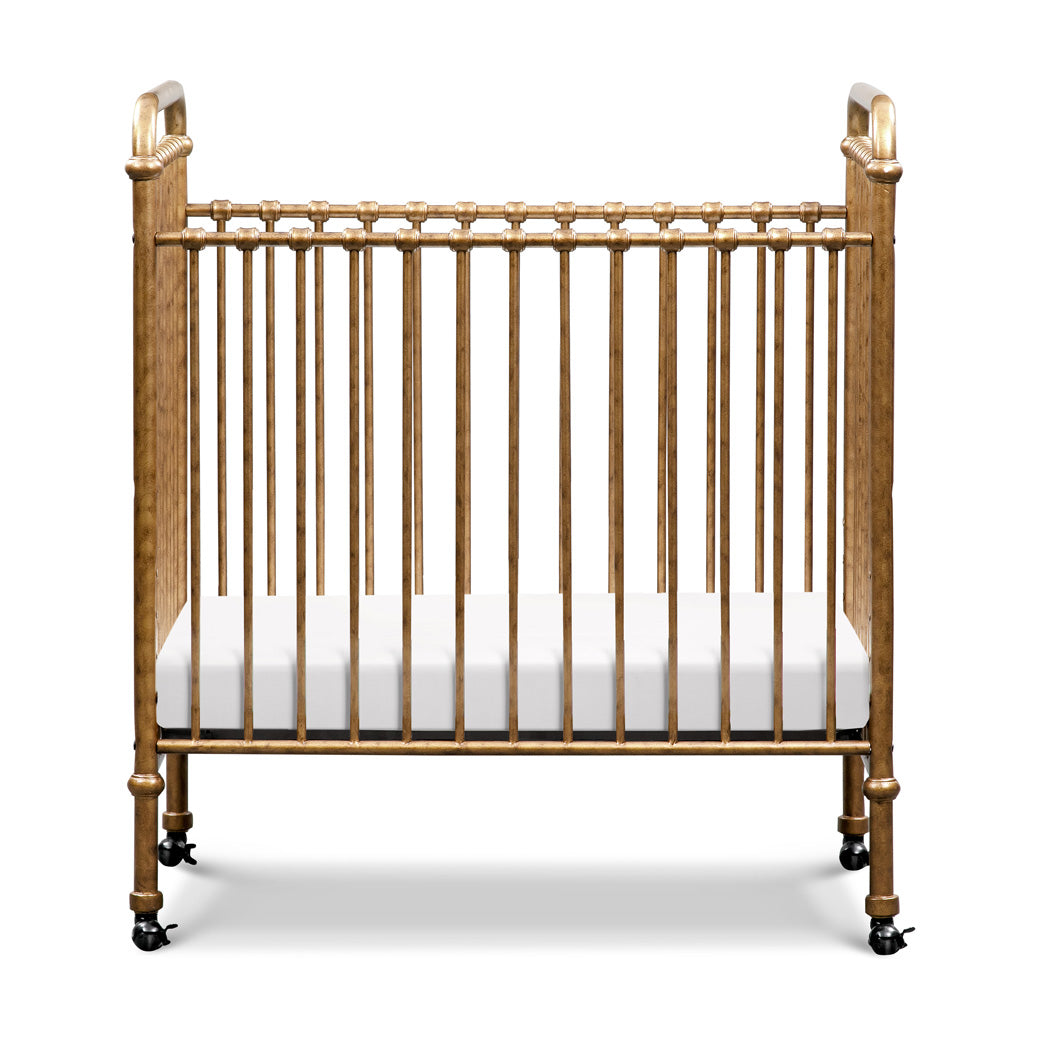 Front view of Namesake`s Abigail 3-in-1 Convertible Mini Crib in -- Color_Vintage Gold
