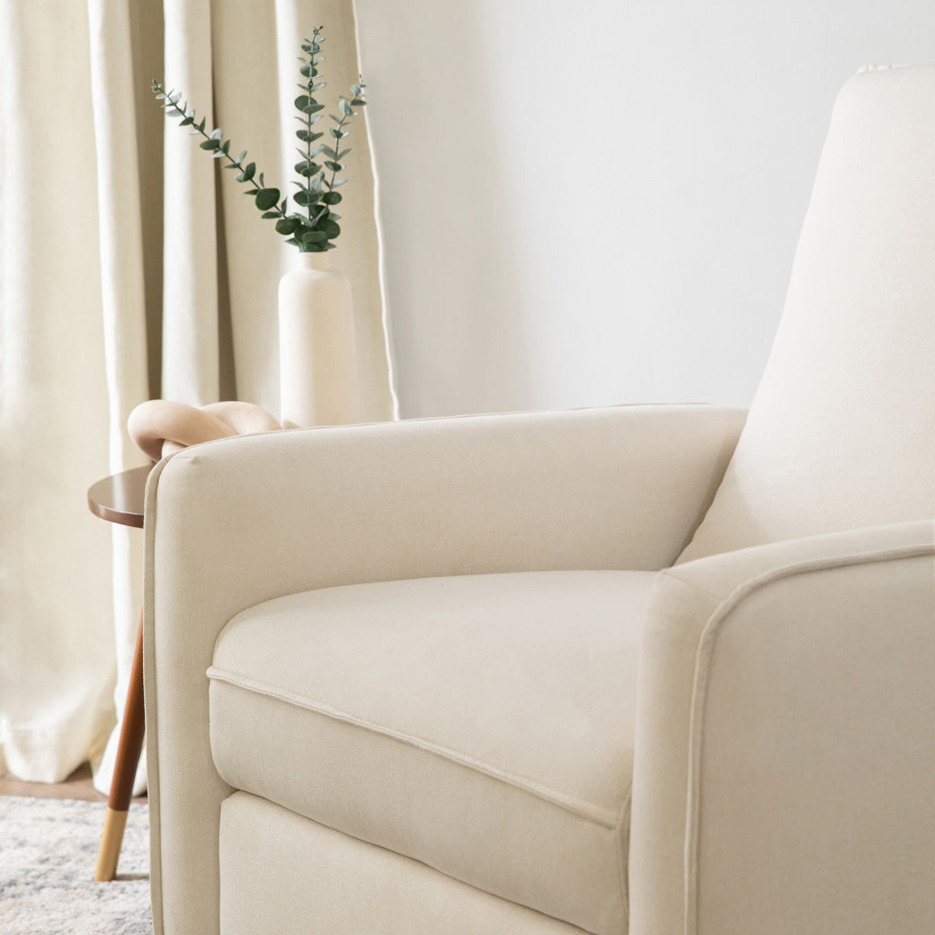 Closeup of the seat of DaVinci's Penny Recliner And Swivel Glider in a room in -- Color_Performance Cream Eco-Weave