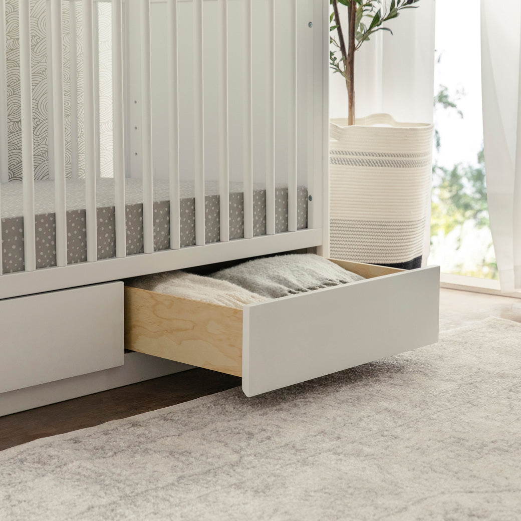 Lifestyle closeup of open drawer of The Babyletto Bento 3-in-1 Convertible Storage Crib with Toddler Bed Conversion Kit in -- Color_White