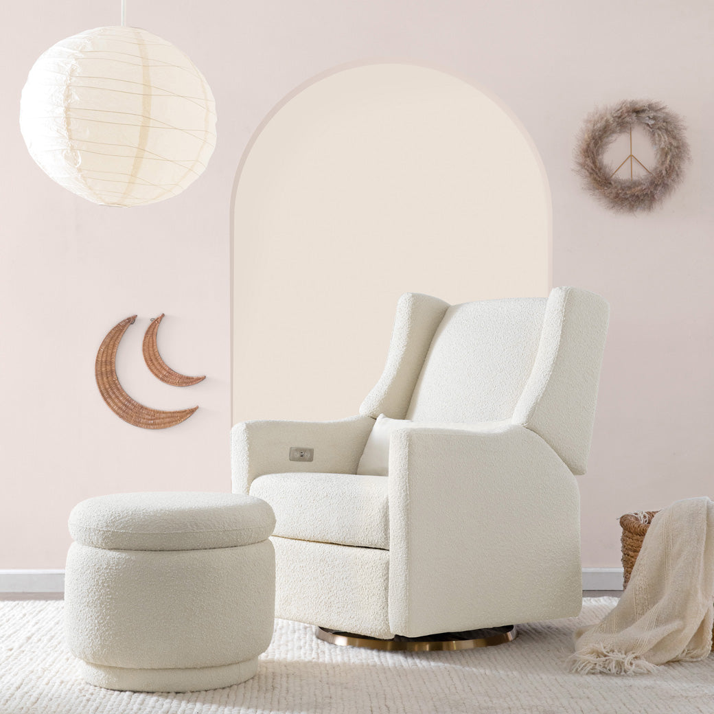 The Babyletto Enoki Storage Ottoman next to a recliner chair  in --Color_Ivory Boucle